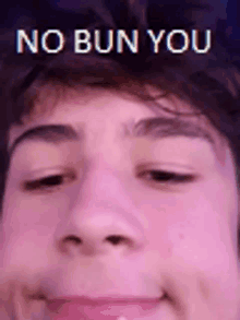 a close up of a person 's face with the words `` no bun you '' written on it .