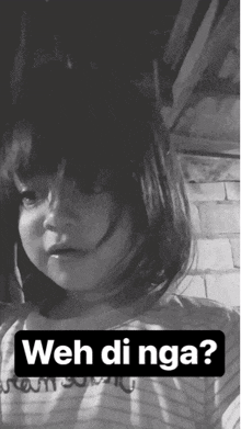 a black and white photo of a little girl with the words weh di nga on the bottom