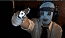 a man with a mask on his face is holding a gun .