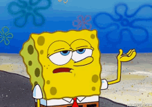 a cartoon of spongebob squarepants standing on a beach with his hand outstretched .