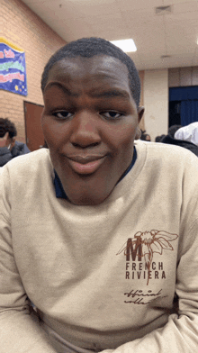 a young man wearing a french riviera sweatshirt