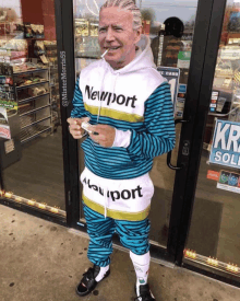 a man standing in front of a store wearing a newport sweatshirt