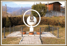 a statue of a man standing in a circle surrounded by a globe