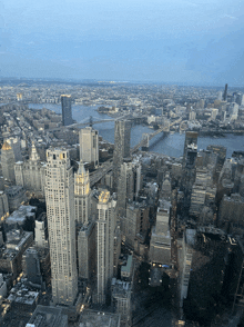 an aerial view of new york city with a bridge in the background