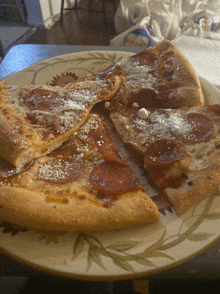 a pepperoni pizza on a plate with a napkin next to it