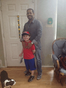 a man and a boy are posing for a picture in front of a door with a growth chart hanging on it