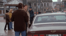 two men are standing in front of a car with a license plate that says ' u.s.a. ' on it