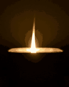 a candle is lit up in the dark with a single flame coming out of it