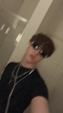 a blurry picture of a person wearing sunglasses and earbuds