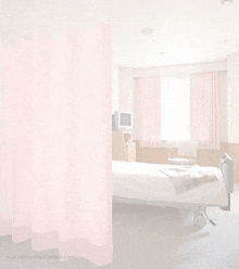 a hospital room with a bed , chair and television .