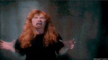 a man with long red hair is making a funny face with the words megadeth gifs written below him