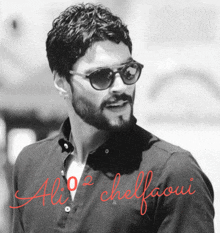 a black and white photo of a man wearing sunglasses and the name ali cheffooui