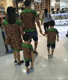 a group of people are walking down a hallway in front of a store called taco