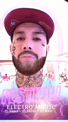 a man with a beard and a tattoo on his face is wearing a hat with the word festival on it