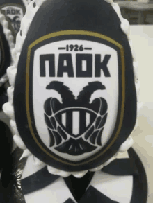 a black and white egg with a logo that says paok