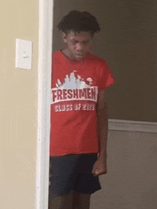 a young man wearing a red shirt that says freshmen class of 2023