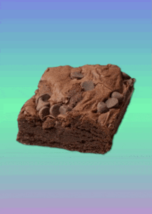 a brownie with chocolate chips on top is on a blue and green background