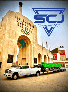 a ram truck is parked in front of a building that says los angeles memorial coliseum