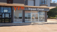 a building with a sign that says yazm insaat emlak on it