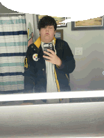 a man taking a selfie in front of a mirror wearing a jacket with a steelers logo on it