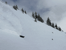 a person is skiing down a snow covered slope