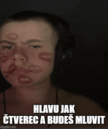 a man wearing headphones has kisses on his face and the caption says hlavu jak oteverec a budes miluvit