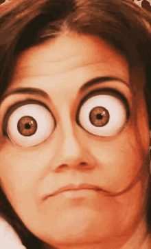 a close up of a woman making a funny face with big eyes