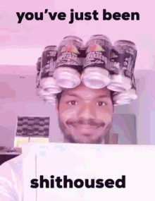 a man with a bunch of cans on his head and the words `` you 've just been shithoused ''