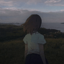 a girl in a white shirt is standing in a field