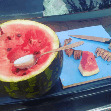 a watermelon with a spoon sticking out of it