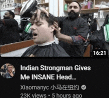 a video of a man getting his hair cut by a barber with the caption indian strongman gives me insane head