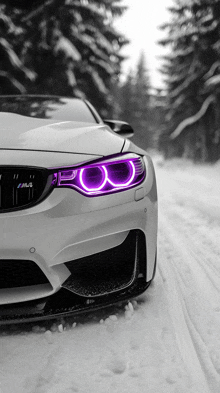 a white car with purple lights on the headlights