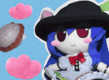 a stuffed doll with blue hair and a black hat is surrounded by pink hearts