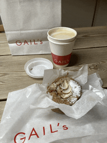 a gail 's bag sits next to a cup of coffee and an apple pie