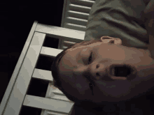 a child is yawning in a crib with his mouth open