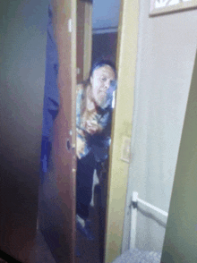 a blurry picture of a man standing in a doorway in a room