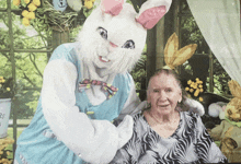 an easter bunny is posing for a picture with an elderly lady