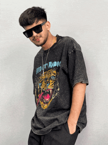 a man wearing sunglasses and a t-shirt with a tiger on it