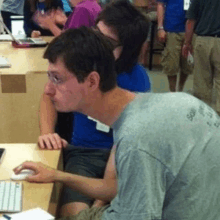 a man wearing a grey shirt that says ' sydney ' on the back