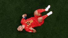 a soccer player with the number 10 on his jersey is laying on the ground