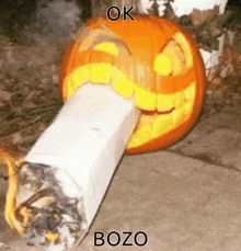 a pumpkin carved to look like a cigarette with bozo written on it