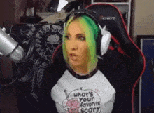 a woman with green hair is wearing headphones and a t-shirt that says what 's your favorite scary