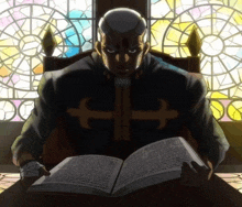 a man with a cross on his jacket is reading a book