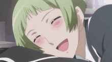 a girl with green hair is smiling and laying down