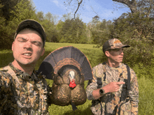 a man in a camo shirt holds a turkey