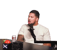 a man sitting in front of a microphone with a box that says " king of the ring " on it