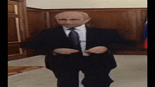 a man in a suit and tie is dancing in a room with his hands in his pockets .