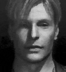 a close up of a man 's face in a black and white photo