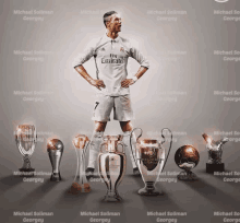 a soccer player wearing a fly emirates jersey stands in front of trophies