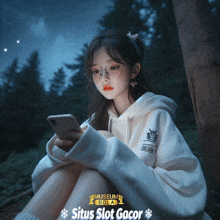 a girl wearing a white hoodie is looking at her phone